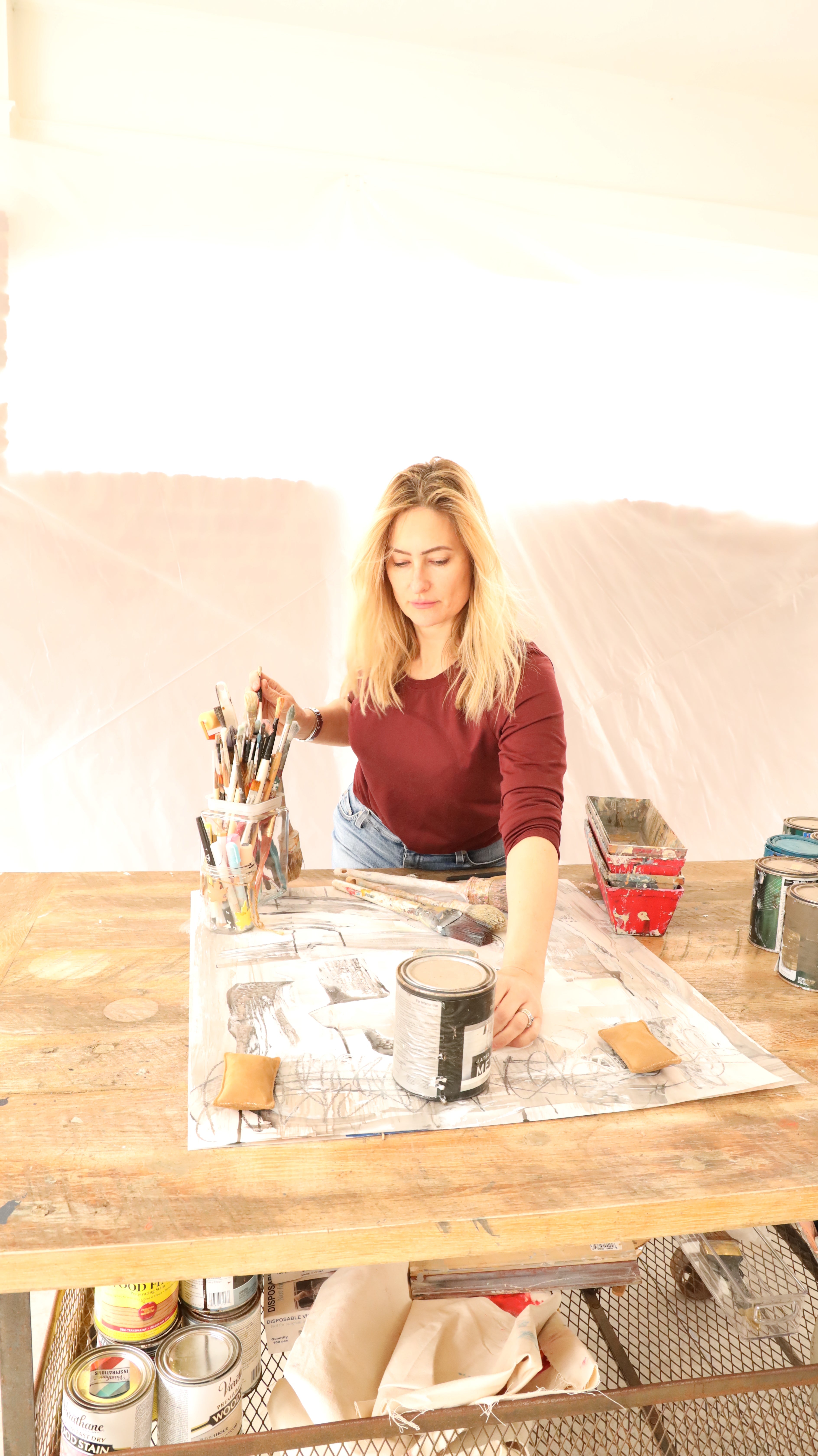 Angela Simeone at her desk in her Nashville studio, working on a new abstract painting