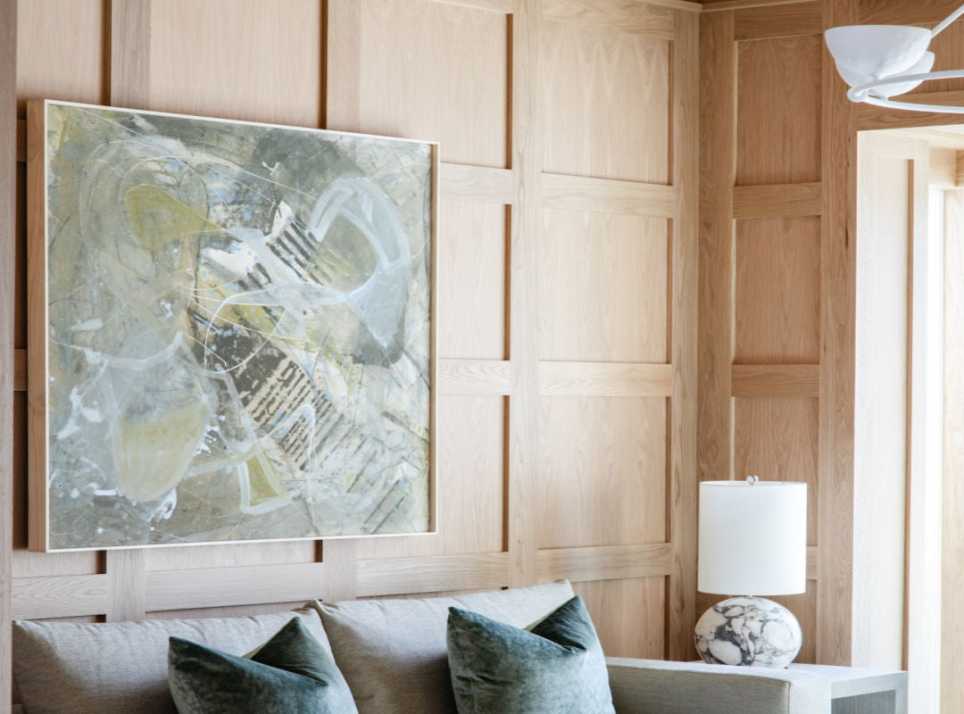 Original abstract painting by Angela Simeone installed above a grey sofa, color anchoring a living room