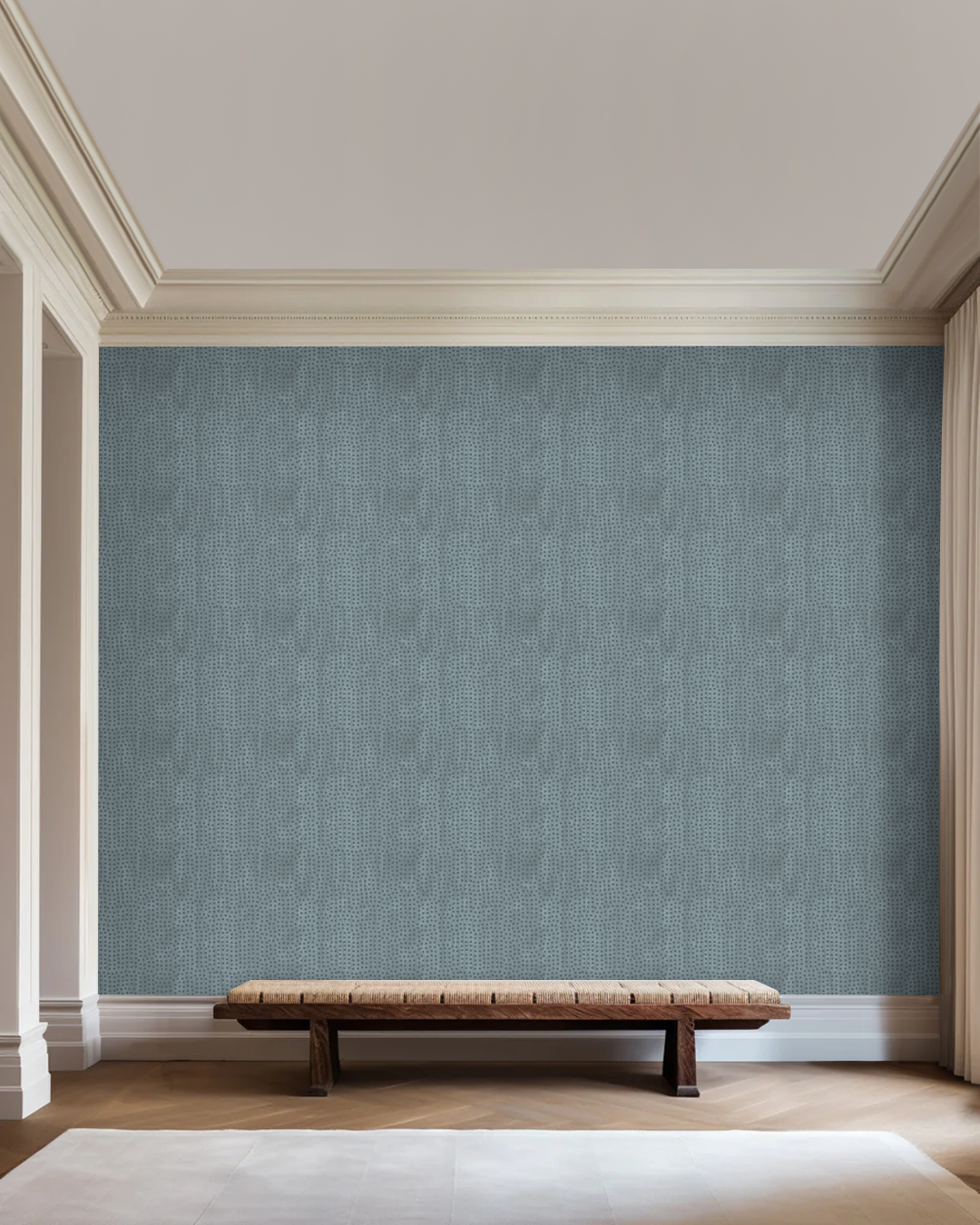 Lavish Blue Grey wallpaper in a high-ceilinged room with a woven wood bench and abstract art by Angela Simeone