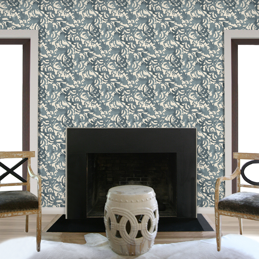 Flourish Storm Blue hand-painted wallpaper by Angela Simeone styled in a living room beside a fireplace