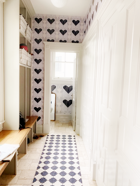 Angela Simeone luxury wallpaper installed on a wall, pattern replacing an all-gray room scheme