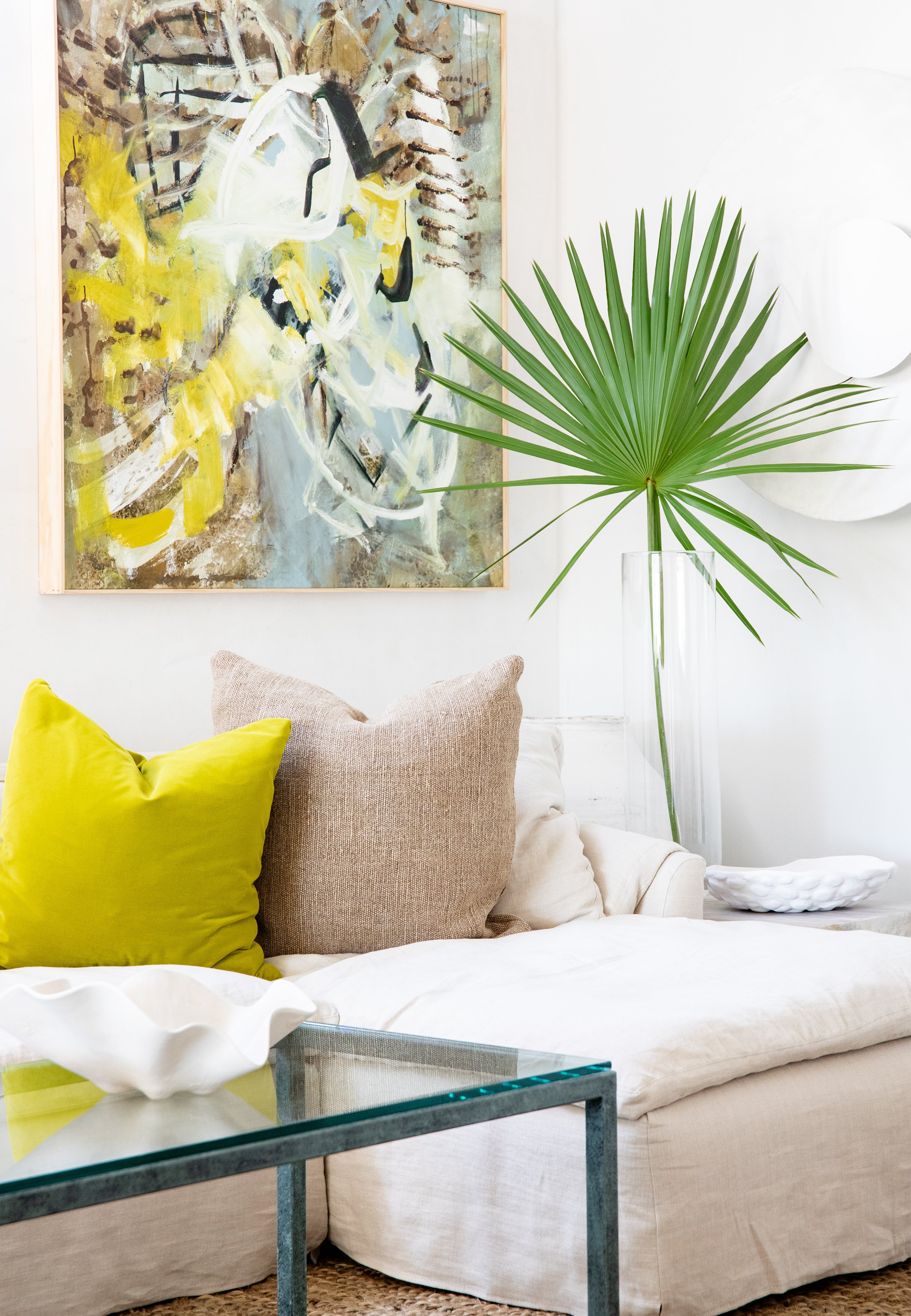 Original abstract painting by Angela Simeone installed above a boucle sofa in a designer living room — a one-of-one original in its home