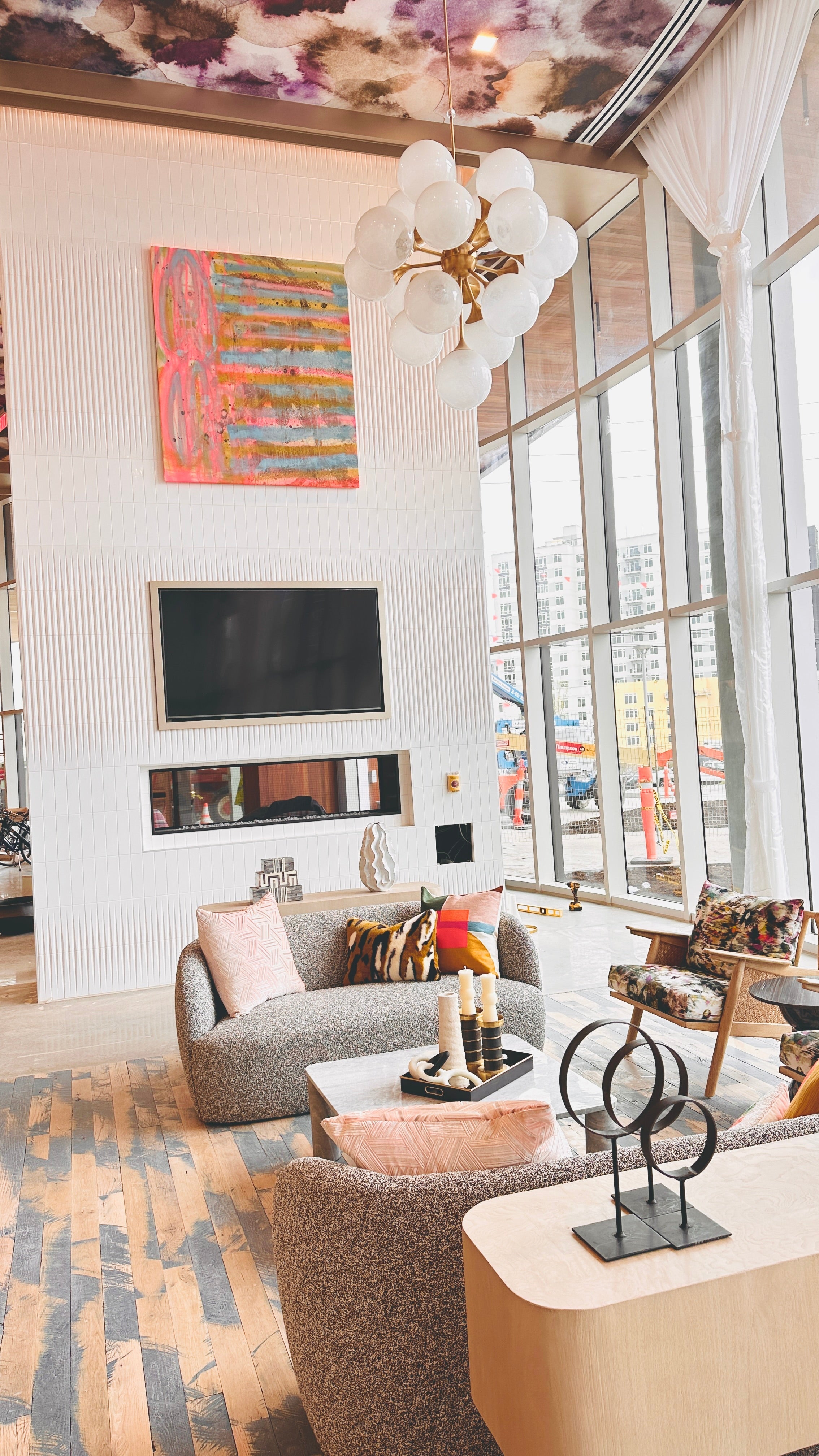 Original abstract painting by Angela Simeone installed above a fireplace in a sitting room at The Albion — art chosen for a living space